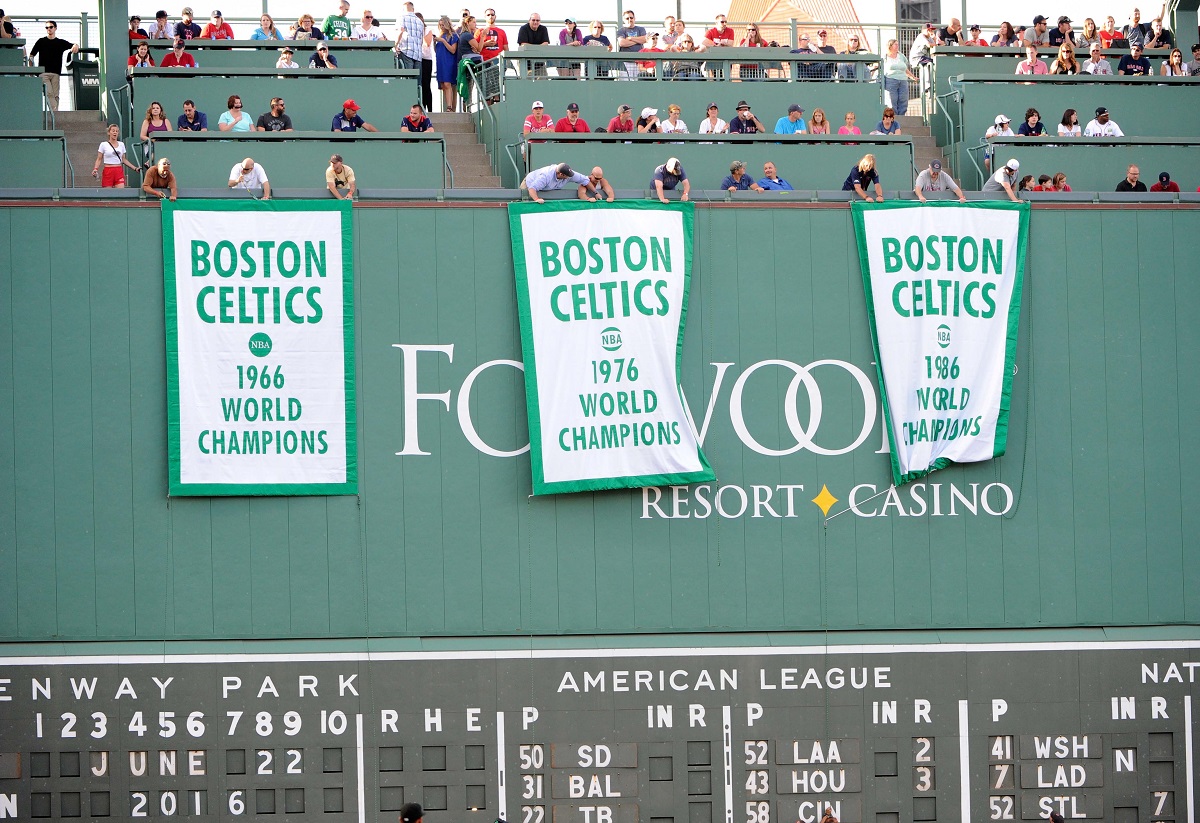 The 1966, 1976 and 1986 Boston Celtics NBA championship banners displayed at a Boston Red Sox baseball game