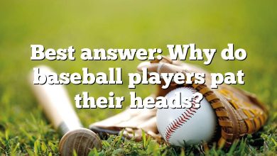 Best answer: Why do baseball players pat their heads?