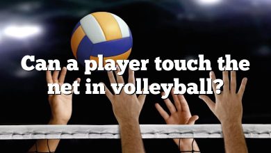 Can a player touch the net in volleyball?