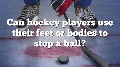 Can hockey players use their feet or bodies to stop a ball?