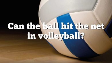 Can the ball hit the net in volleyball?