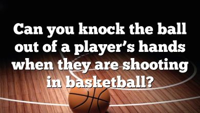 Can you knock the ball out of a player’s hands when they are shooting in basketball?