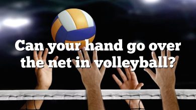 Can your hand go over the net in volleyball?