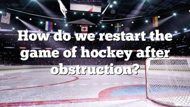 How do we restart the game of hockey after obstruction?