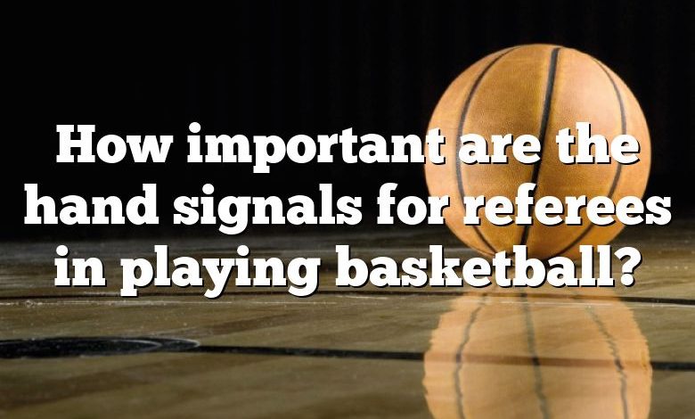 How important are the hand signals for referees in playing basketball?