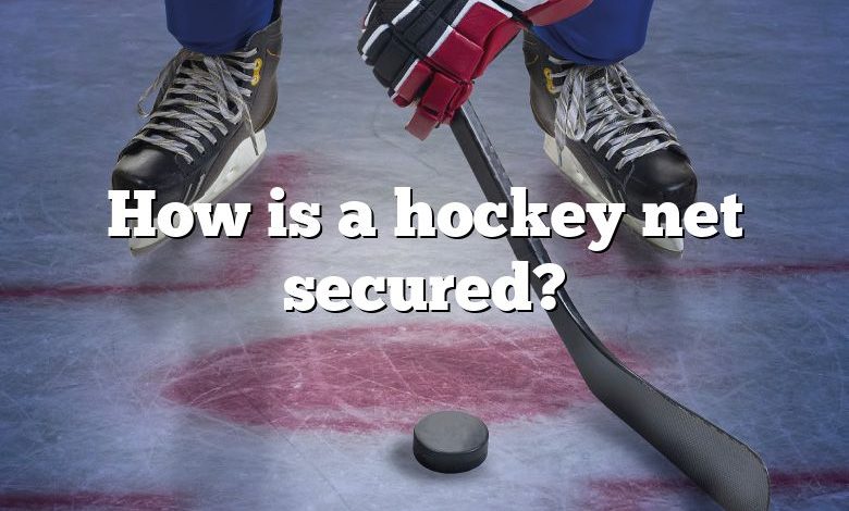 How is a hockey net secured?