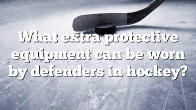 What extra protective equipment can be worn by defenders in hockey?