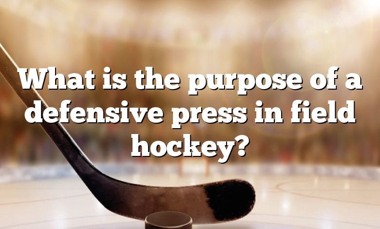 What is the purpose of a defensive press in field hockey?