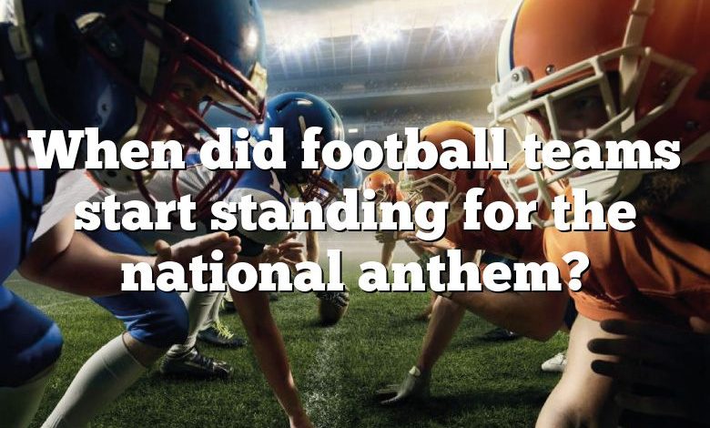 When did football teams start standing for the national anthem?