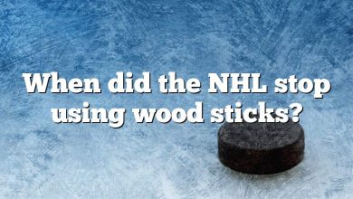 When did the NHL stop using wood sticks?