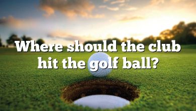 Where should the club hit the golf ball?