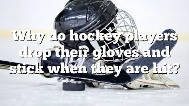 Why do hockey players drop their gloves and stick when they are hit?