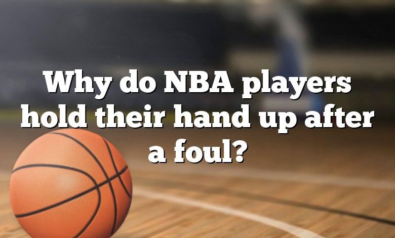 Why do NBA players hold their hand up after a foul?